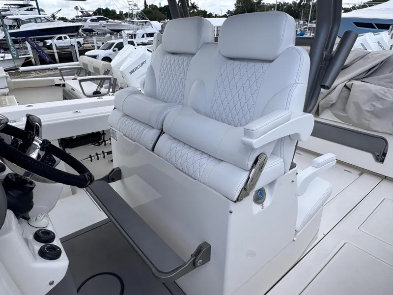 Slide: The Image of Luxury seating on 2025 Solace 32 CS boat, featuring plush white upholstery and modern design. - 30