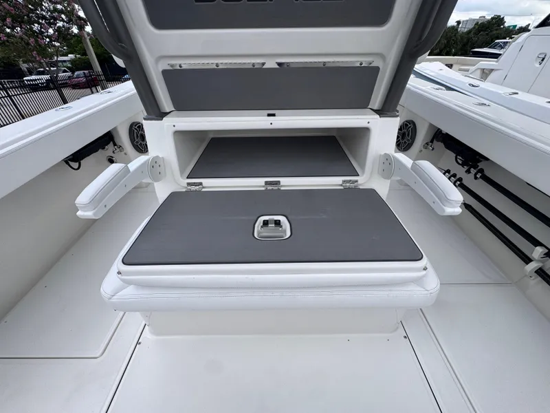 Slide: The Image of 2025 Solace 32 CS boat with open storage compartment and seating area. - 36