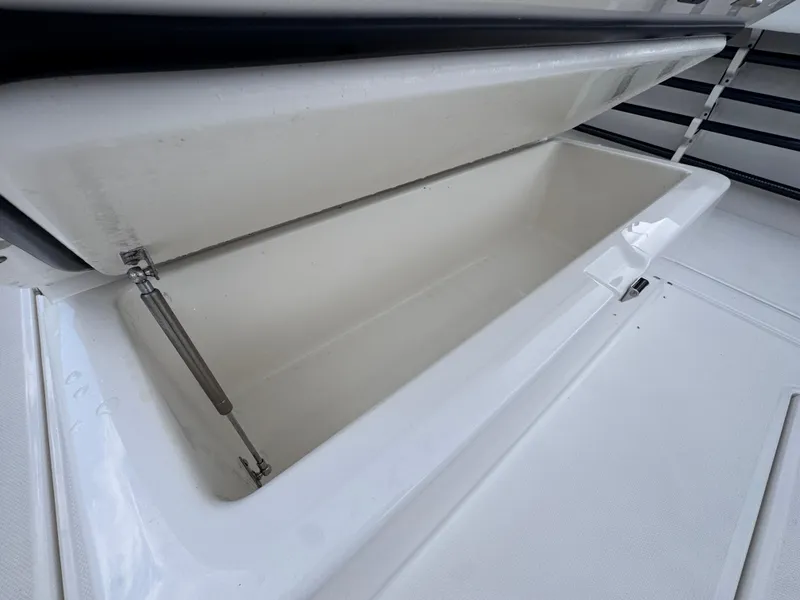 Slide: The Image of Open storage compartment on 2025 Solace 32 CS boat, showcasing spacious interior. - 37