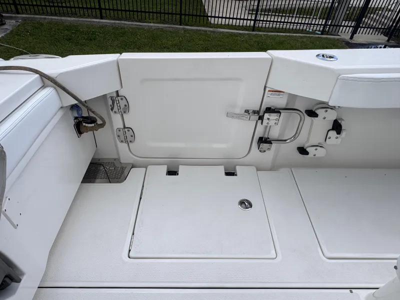 Slide: The Image of 2025 Solace 32 CS boat deck with storage compartments and safety features. - 38