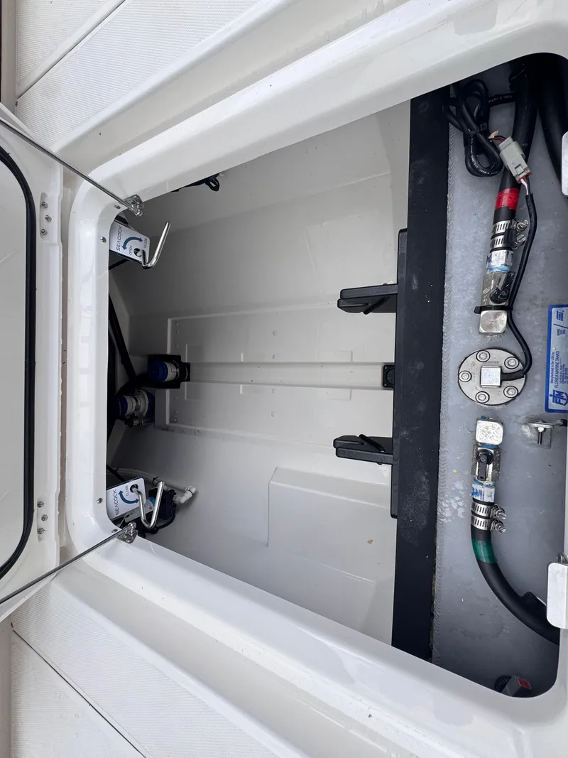 Slide: The Image of 2025 Solace 32 CS boat storage compartment with visible wiring and fittings. - 48