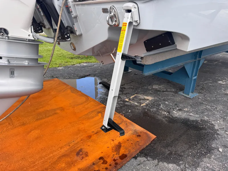 Slide: The Image of 2025 Solace 32 CS boat with ladder on orange mat, docked on a stand. - 6