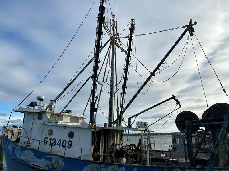 The Image of Vintage 1979 Custom Steel Trawler Dragger docked under cloudy sky. - 0