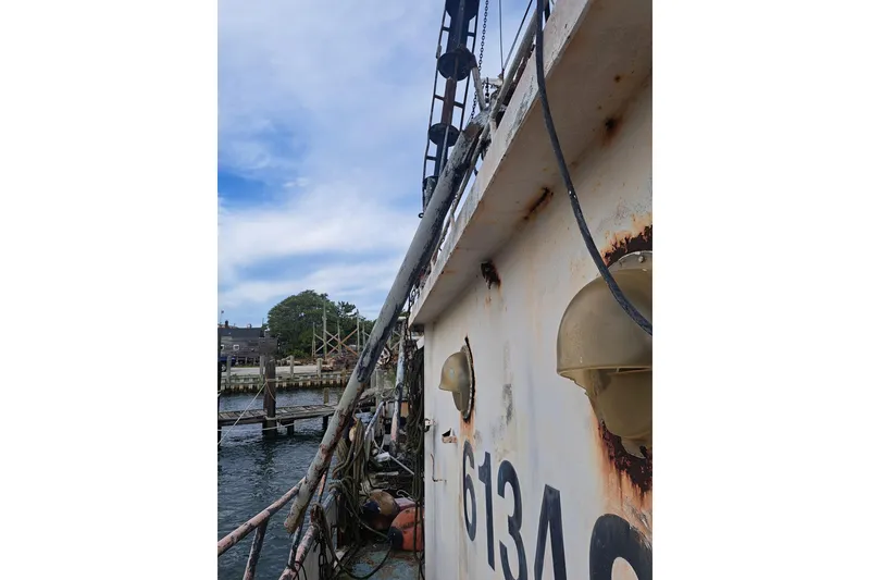 Slide: The Image of Rusty 1979 Custom Steel Trawler Dragger docked by the waterfront. - 11