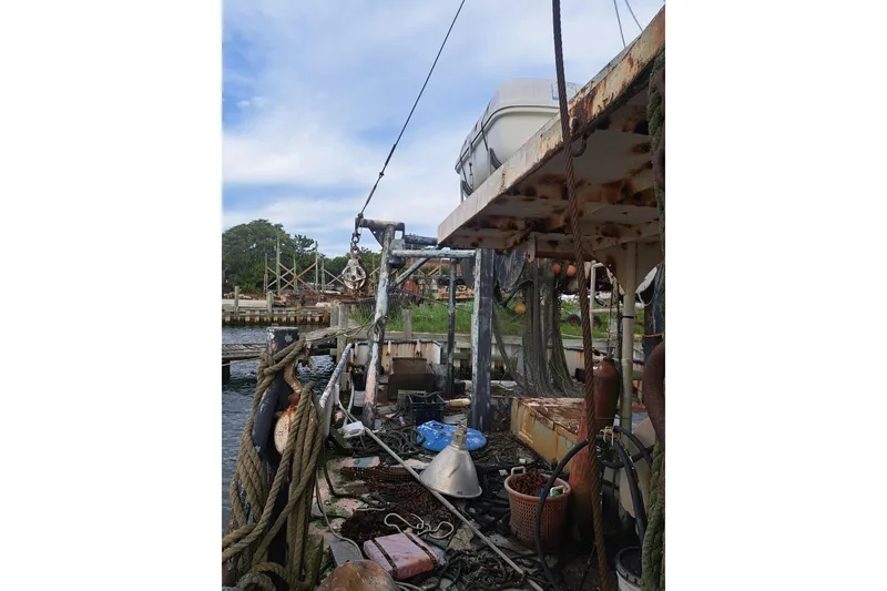 Slide: The Image of Rustic 1979 Custom Steel Trawler Dragger with fishing equipment and ropes on deck. - 12