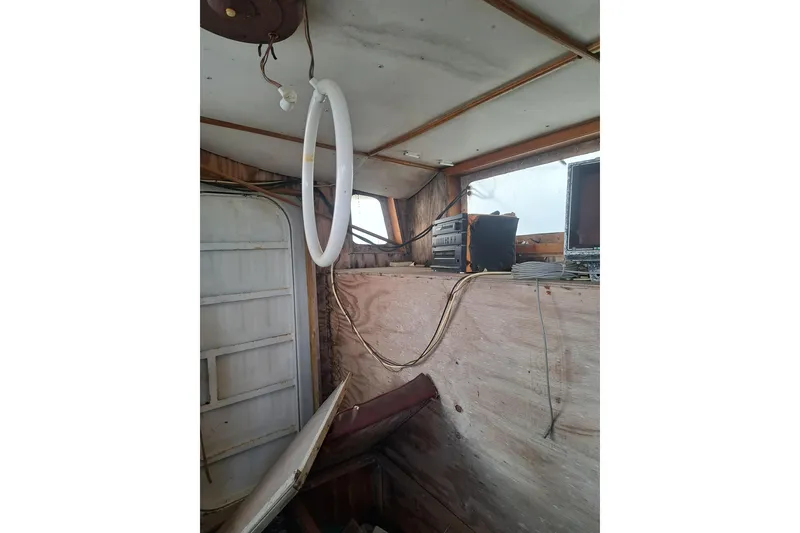 Slide: The Image of Interior of a 1979 Custom Steel Trawler Dragger with vintage equipment and wooden paneling. - 21
