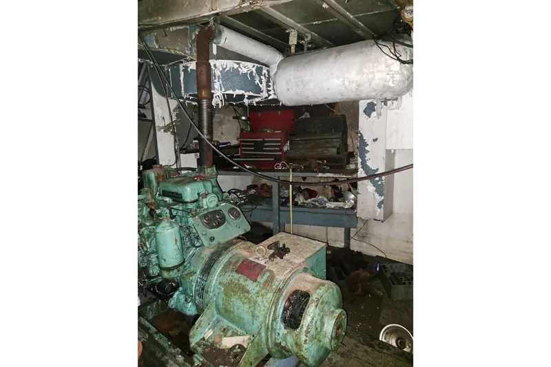 Slide: The Image of Engine room of a 1979 Custom Steel Trawler Dragger with visible machinery and equipment. - 24