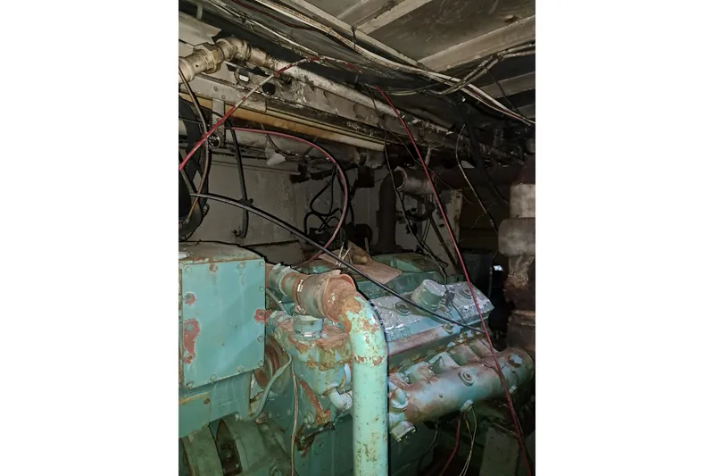 Slide: The Image of Engine room of a 1979 Custom Steel Trawler Dragger with visible wiring and machinery. - 25