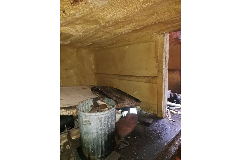 Slide: The Image of Interior of a 1979 Custom Steel Trawler Dragger, showing storage area with metal bin. - 27