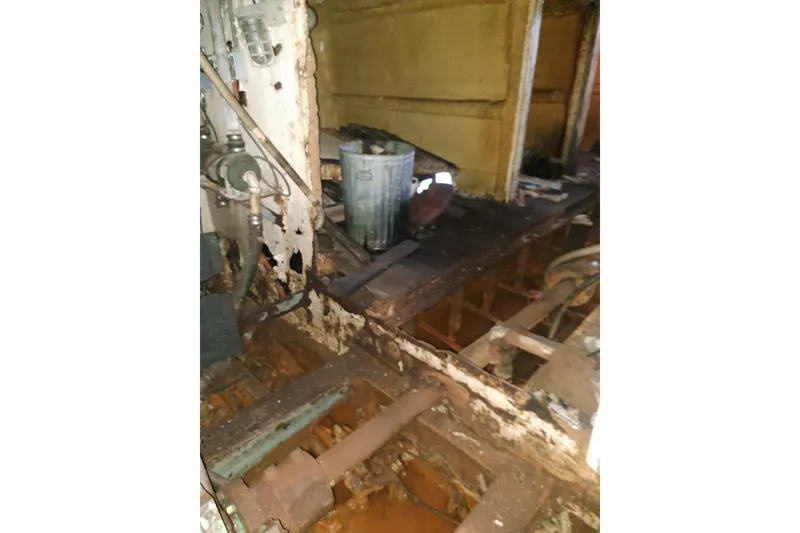 Slide: The Image of Interior of a 1979 Custom Steel Trawler Dragger, showing rust and structural wear. - 28