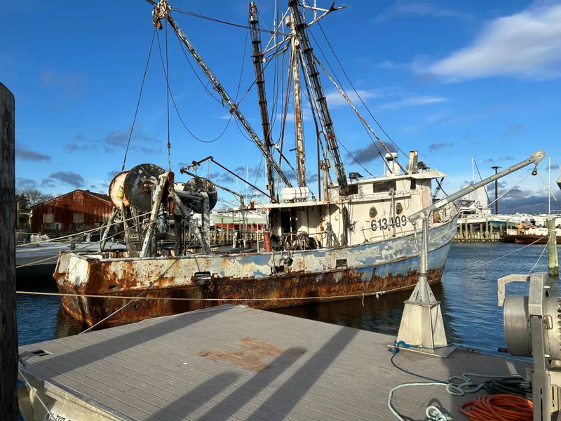 Slide: The Image of Old steel trawler dragger docked at harbor, Custom model, 1979, with visible rust and fishing equipment. - 3