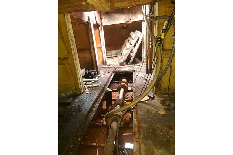 Slide: The Image of Interior of a 1979 Custom Steel Trawler Dragger, showing machinery and cables. - 30