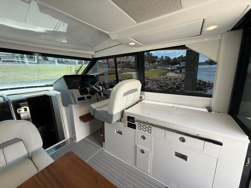 Slide: The Image of Interior of 2022 Regal 36 Grande Coupe yacht with modern helm and seating. - 11