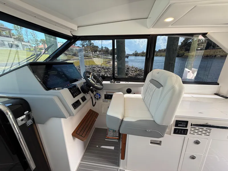 Slide: The Image of 2022 Regal 36 Grande Coupe helm with modern controls and comfortable seating. - 12