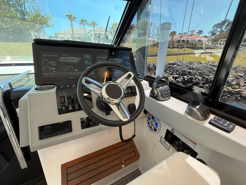 Slide: The Image of 2022 Regal 36 Grande Coupe helm with modern controls and navigation display. - 14