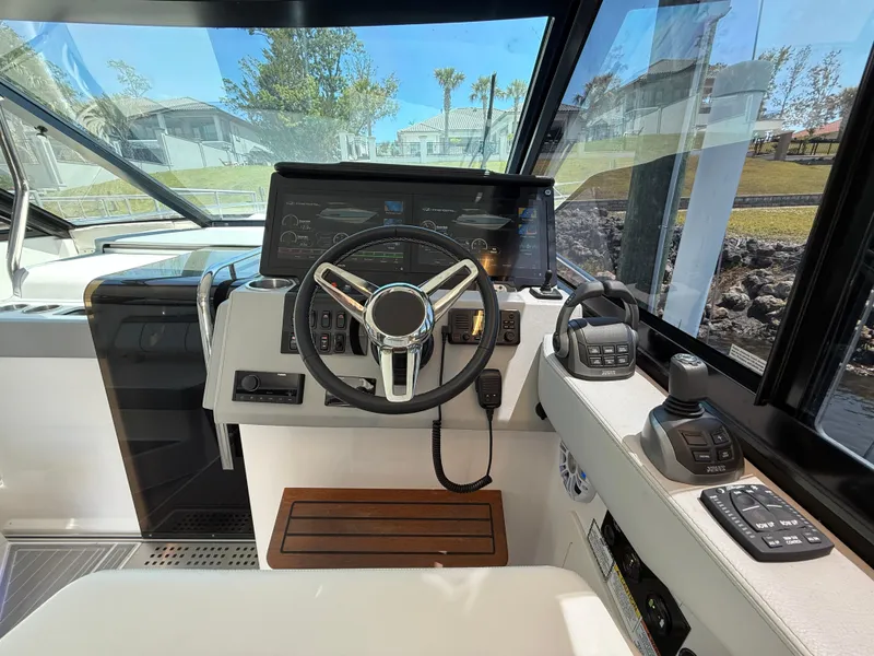 Slide: The Image of 2022 Regal 36 Grande Coupe helm with modern controls and navigation display. - 15