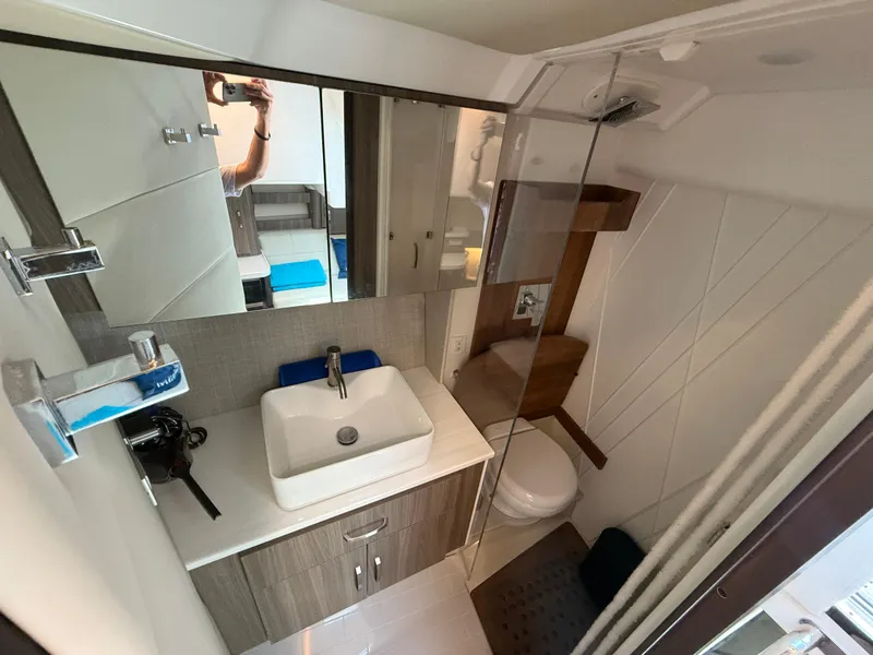 Slide: The Image of 2022 Regal 36 Grande Coupe bathroom with modern sink, mirror, and shower. - 18