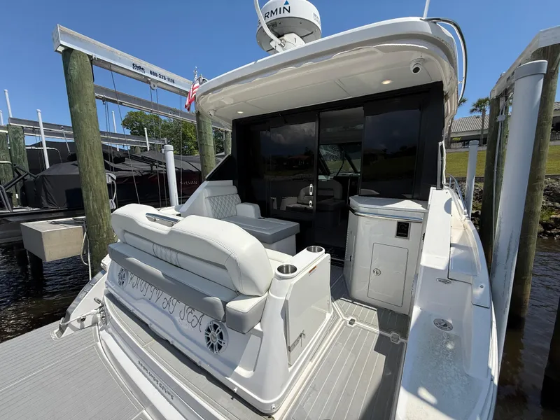 Slide: The Image of 2022 Regal 36 Grande Coupe yacht with spacious deck and seating area. - 3