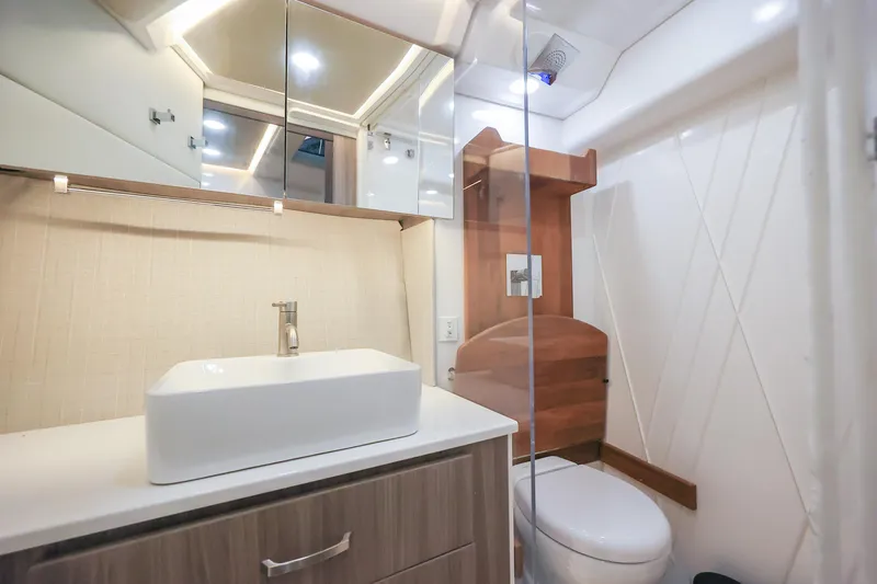 Slide: The Image of Modern bathroom interior of 2022 Regal 36 Grande Coupe yacht, featuring sleek sink and toilet. - 37