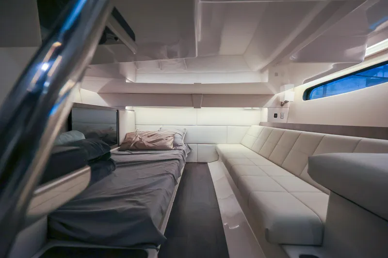 Slide: The Image of Luxurious interior of 2022 Regal 36 Grande Coupe yacht with modern seating and bedding. - 43