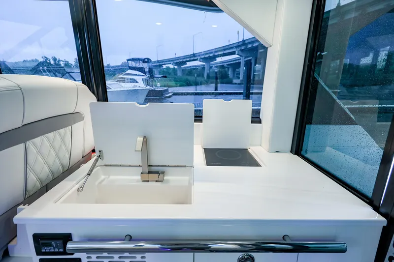 Slide: The Image of Interior of 2022 Regal 36 Grande Coupe yacht with modern kitchenette and sleek design. - 46