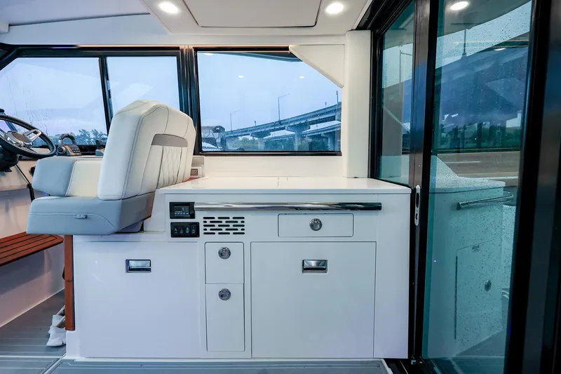 Slide: The Image of Interior of 2022 Regal 36 Grande Coupe, featuring helm seat and sleek cabinetry. - 47