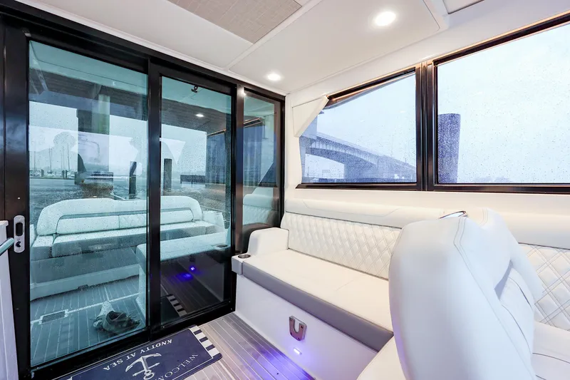 Slide: The Image of Luxurious interior of 2022 Regal 36 Grande Coupe yacht with plush seating and large windows. - 48