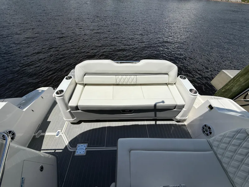 Slide: The Image of 2022 Regal 36 Grande Coupe boat with elegant white seating on deck. - 6