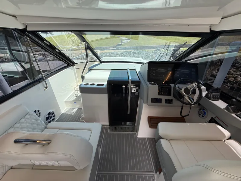 Slide: The Image of 2022 Regal 36 Grande Coupe cockpit with modern controls and luxurious seating. - 9