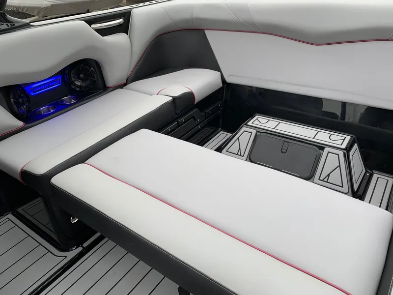 Slide: The Image of 2019 Moomba Craz boat interior with white seating, cup holders, and blue LED lighting. - 12