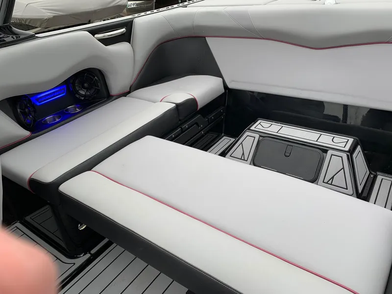 Slide: The Image of 2019 Moomba Craz interior with gray seating, cup holders, and blue LED lighting. - 14