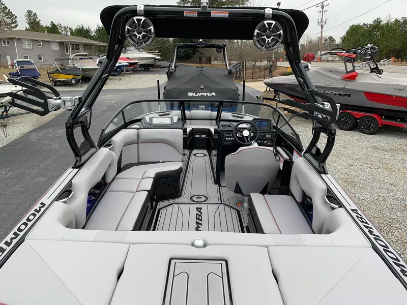 Slide: The Image of 2019 Moomba Craz boat interior with seating and dashboard, parked outdoors. - 15