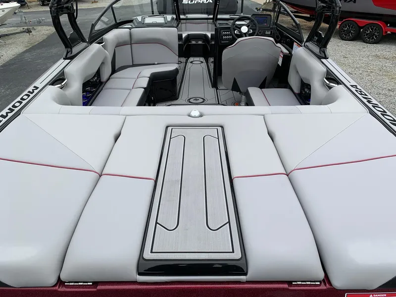 Slide: The Image of 2019 Moomba Craz boat interior with gray seating and modern dashboard. - 20