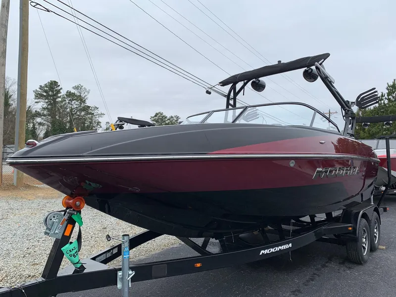 Slide: The Image of 2019 Moomba Craz boat on trailer, black and red design, parked outdoors. - 3