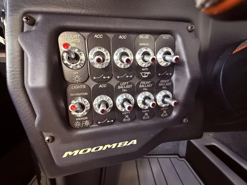Slide: The Image of Control panel of a 2019 Moomba Craz boat with various switches. - 33