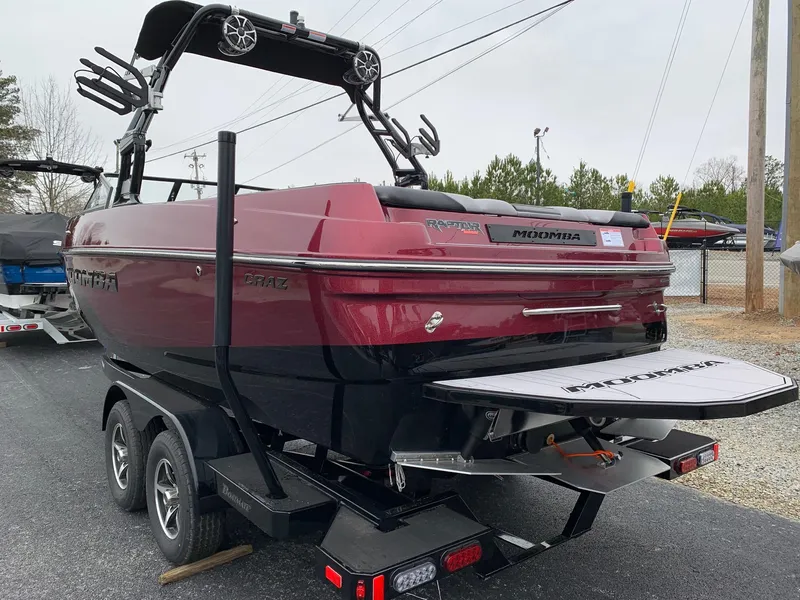 Slide: The Image of 2019 Moomba Craz boat on trailer, maroon color, with wakeboard tower and speakers. - 4