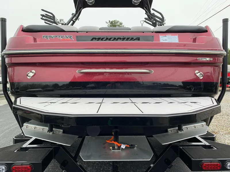 Slide: The Image of 2019 Moomba Craz boat rear view, featuring Raptor engine and swim platform. - 6