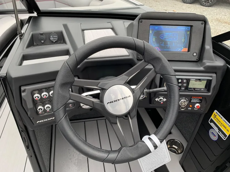 Slide: The Image of 2019 Moomba Craz boat dashboard with steering wheel and digital display. - 8