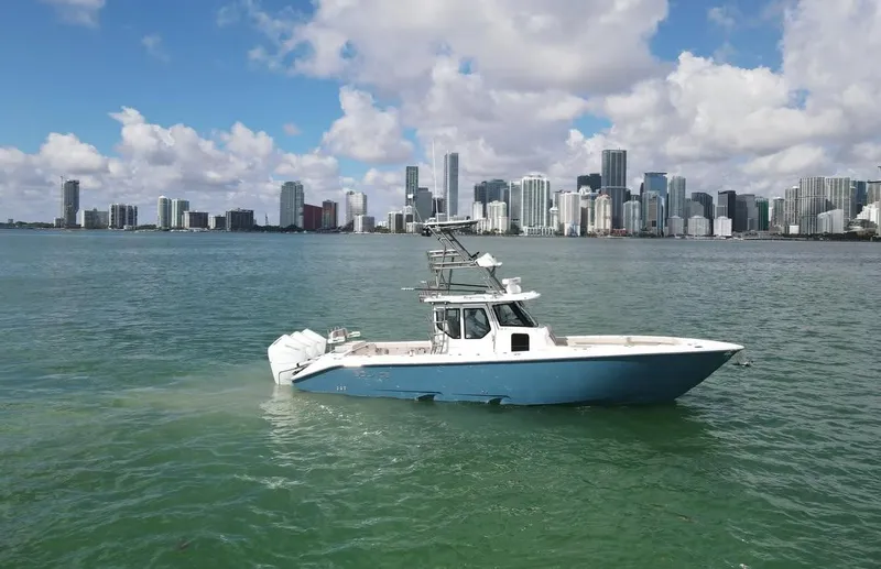 Slide: The Image of Solace 37 CS 2025 boat on water with city skyline in background. - 2