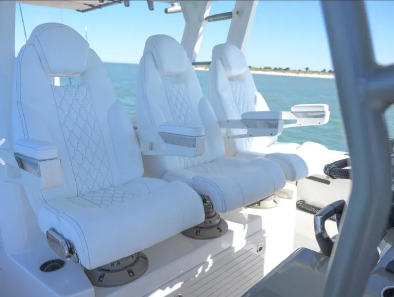 Slide: The Image of Luxury seating on 2024 Solace 37 CS boat, featuring white leather captain chairs. - 15
