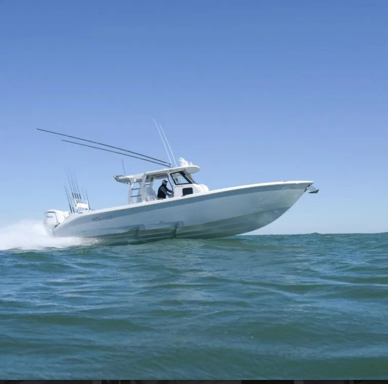 Slide: The Image of 2024 Solace 37 CS boat cruising on open water under clear blue sky. - 18