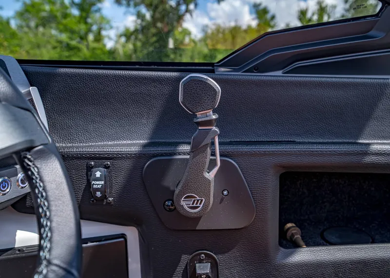 Slide: The Image of 2024 Malibu Wakesetter 24 MXZ interior dashboard with power seat control and steering details. - 22