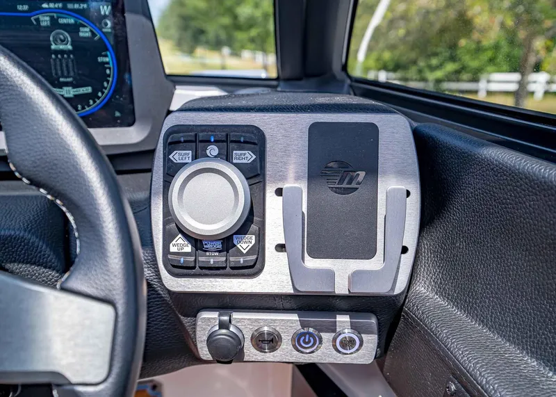Slide: The Image of 2024 Malibu Wakesetter 24 MXZ dashboard controls with steering wheel detail. - 23