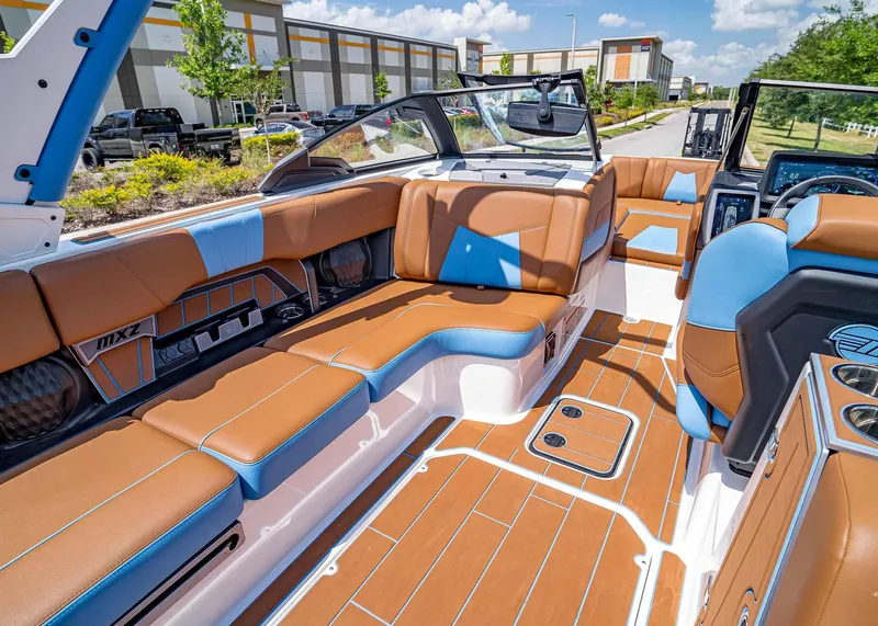 Slide: The Image of 2024 Malibu Wakesetter 24 MXZ interior with brown and blue seating, modern design. - 25