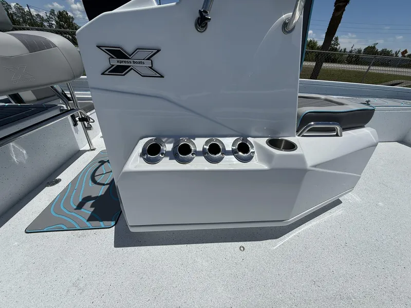 Slide: The Image of 2025 Xpress Hyper-Lift Series H22B boat console with rod holders and seating. - 6
