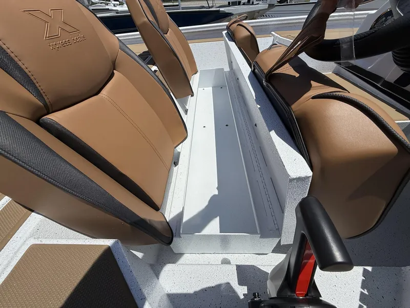 Slide: The Image of 2025 Xpress Hyper-Lift Bass Series boat seats with tan upholstery and sleek design. - 5