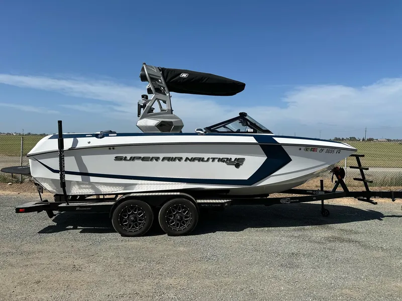 Slide: The Image of 2019 Nautique Super Air Nautique G23 boat on trailer, side view, clear sky background. - 0
