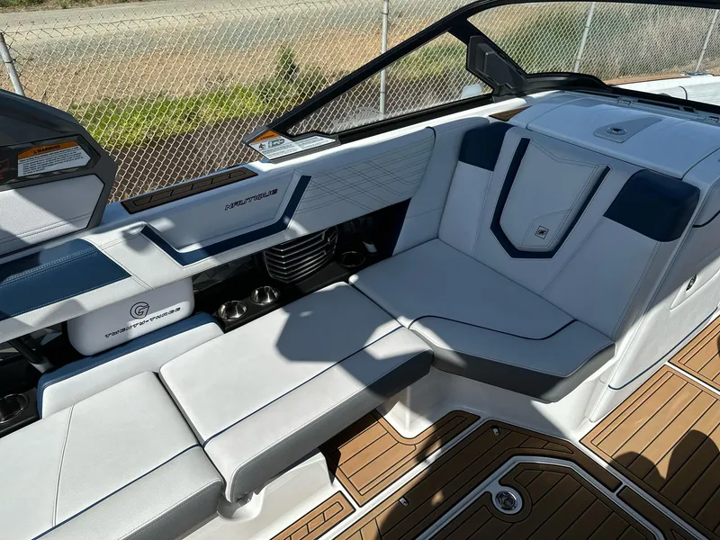 Slide: The Image of 2019 Nautique Super Air Nautique G23 interior with white and blue seating. - 10
