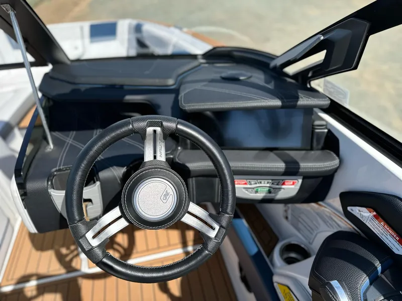 Slide: The Image of 2019 Nautique Super Air Nautique G23 steering wheel and dashboard, featuring sleek design and controls. - 13