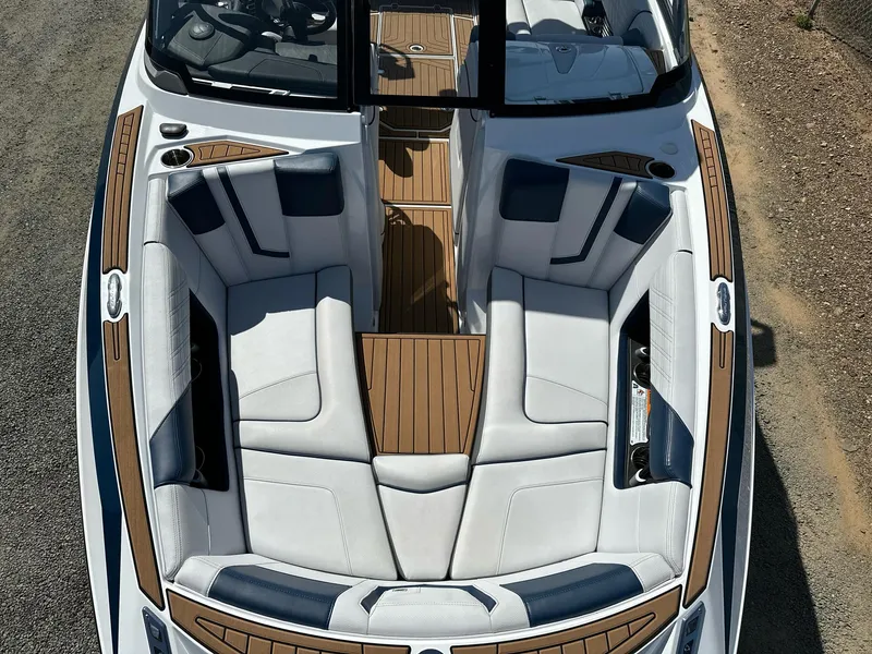 Slide: The Image of 2019 Nautique Super Air Nautique G23 boat interior with luxurious seating and wood accents. - 9